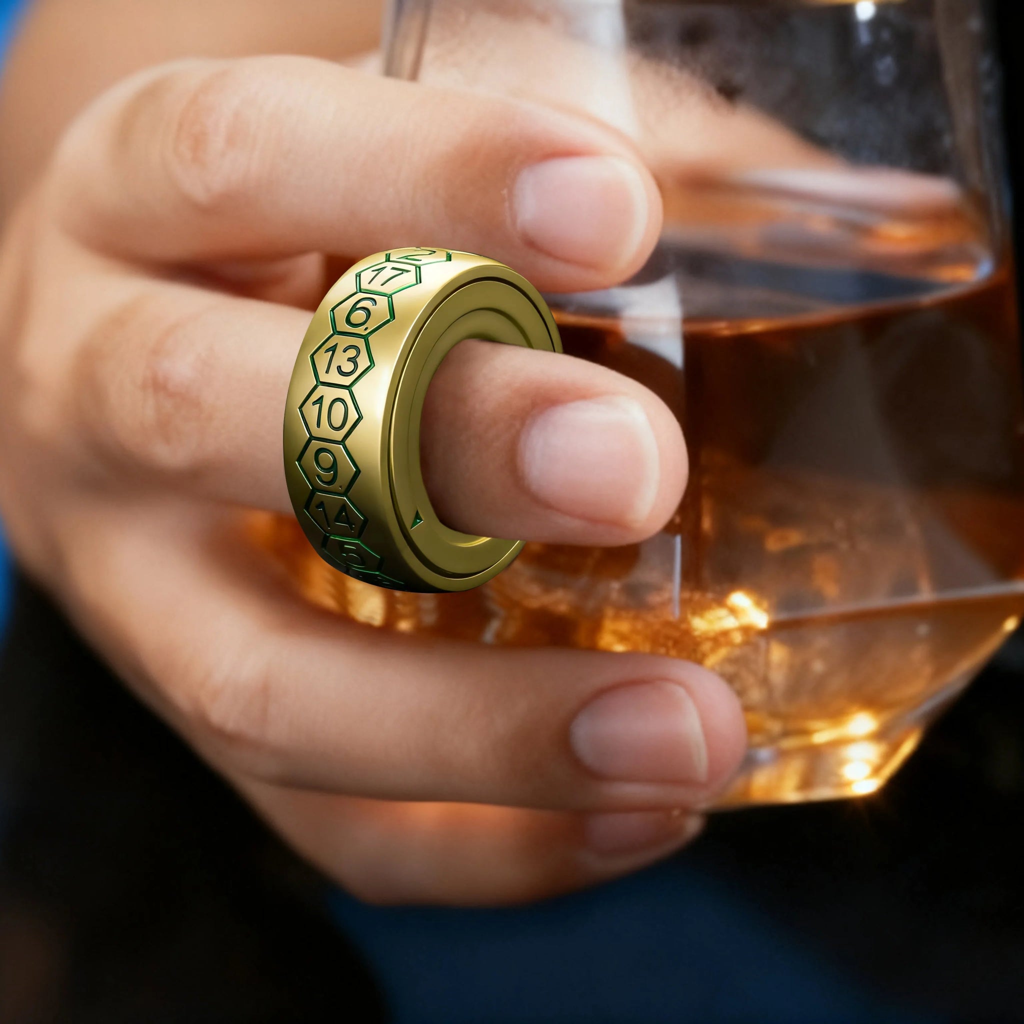 Cool gold-plated metal spinning D20 dice ring with green numbers, wearable on your hand and spins | Bear Dice
