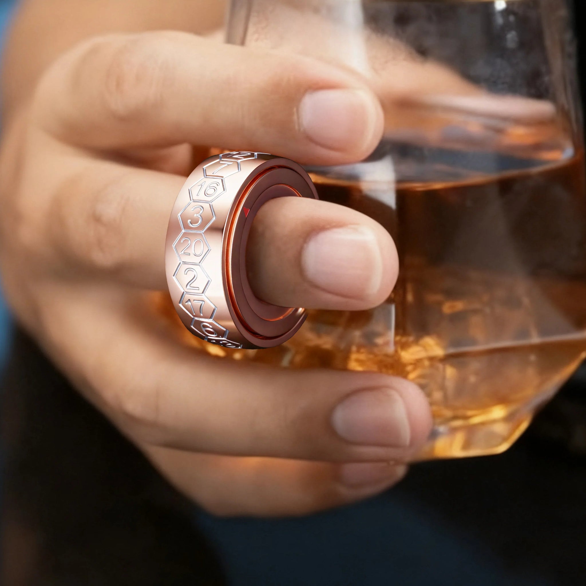 Cool copper-colored rotating D20 dice ring with white numbers, wearable on the hand and spinning | Bear Dice