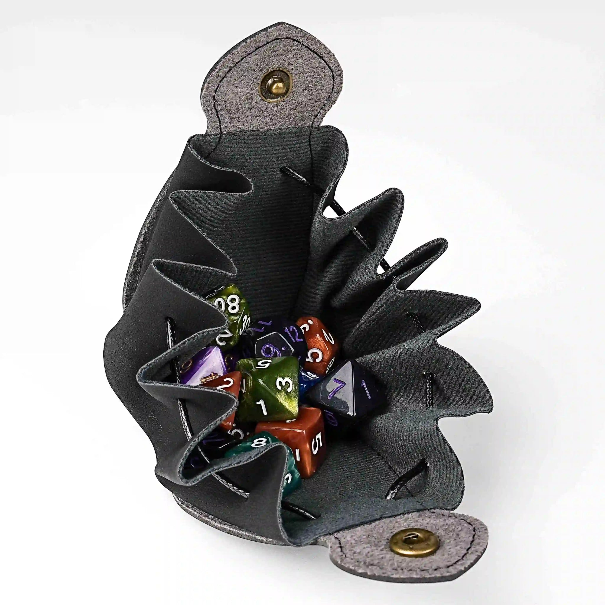 Interior details of the handcrafted black leather DND drawstring dice bag with button closure and printed Bear Dice logo, holds two sets of acrylic dice | Bear Dice