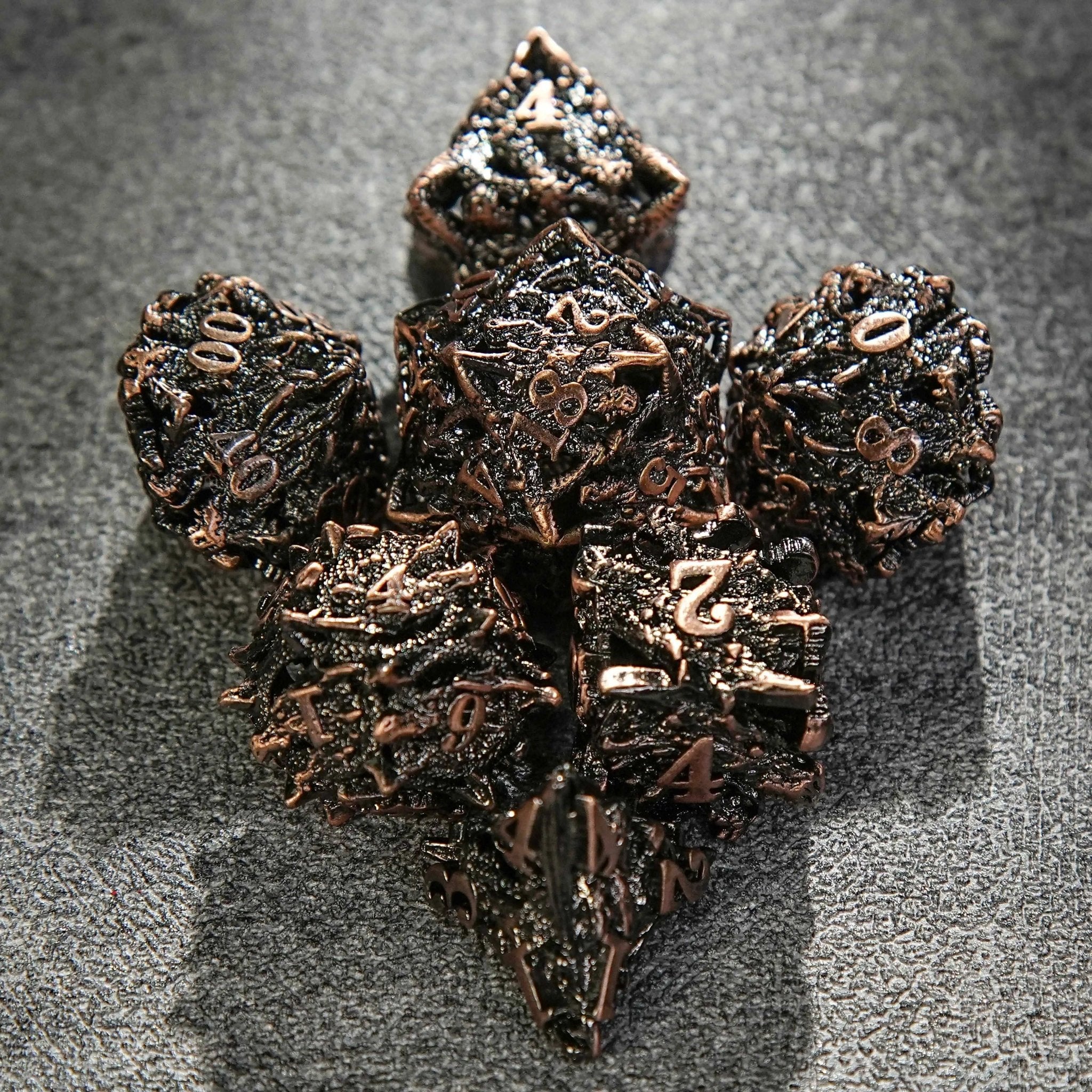 Seven copper-colored metal hollow dragon head dice arranged in the shape of an arrow | Bear Dice