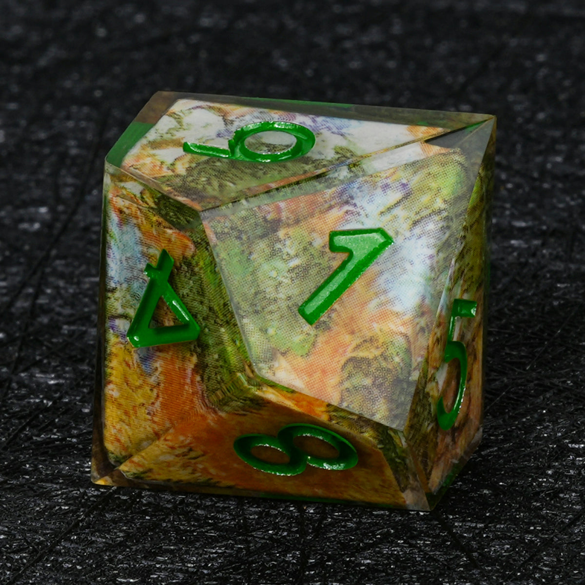 Ten-sided resin D10 with autumn landscape decal artwork, green numbers and a clear outer layer