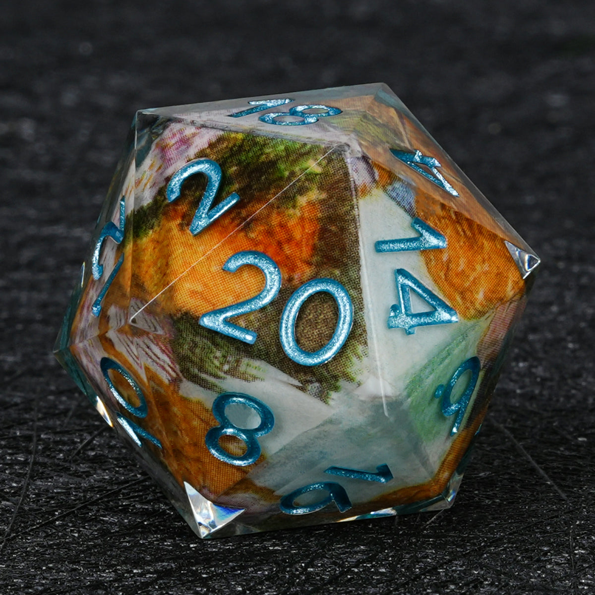 Resin D20 with autumn landscape decal artwork, metallic blue numbers and clear sharp edges