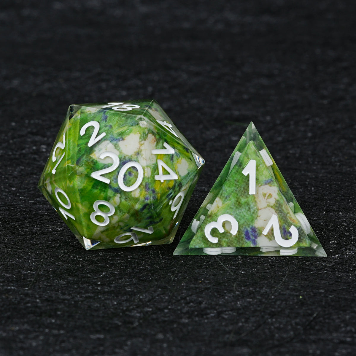 Green floral resin D20 and pyramid-shaped D4 with white numbers, cream-white floral artwork and clear sharp edges