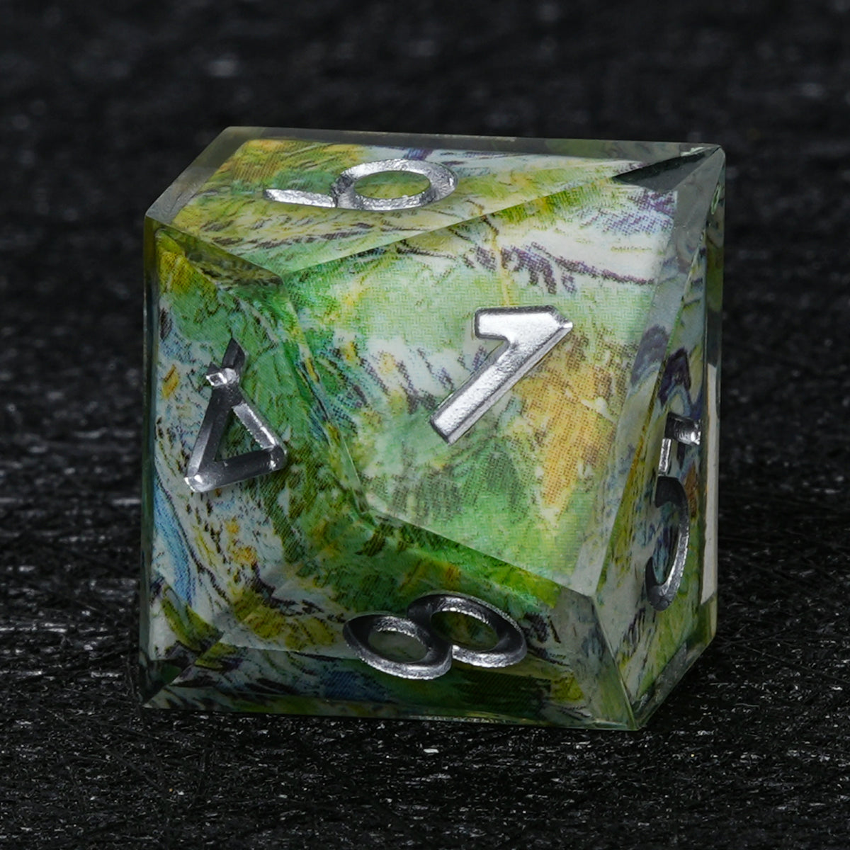 Ten-sided green landscape resin D10 with silver-colored numbers, pale blue and white accents and a clear outer layer