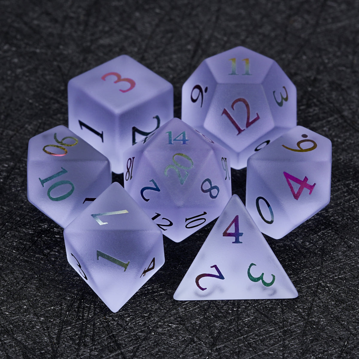 Seven-piece lavender gemstone dice set with multicolored numbers, including D4, D6, D8, D10, D100, D12, and D20 arranged together