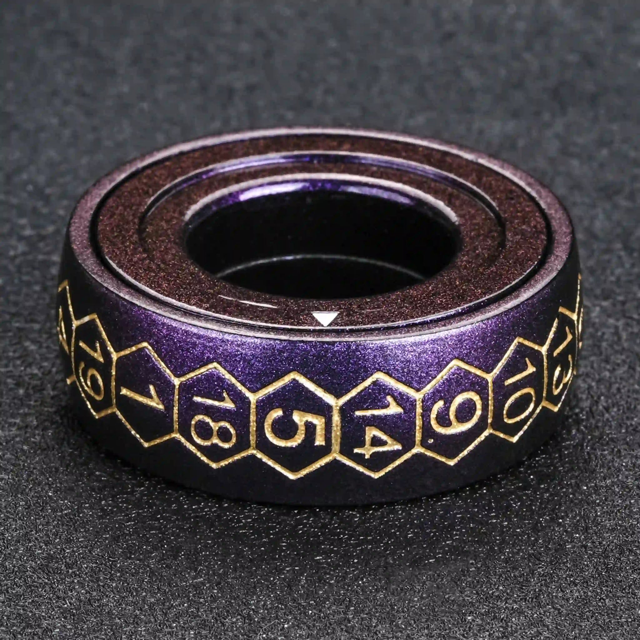 Cool purple metal fingertip spinning D20 dice ring with gold numbers, arrows in the middle layer pointing to the final reading | Bear Dice