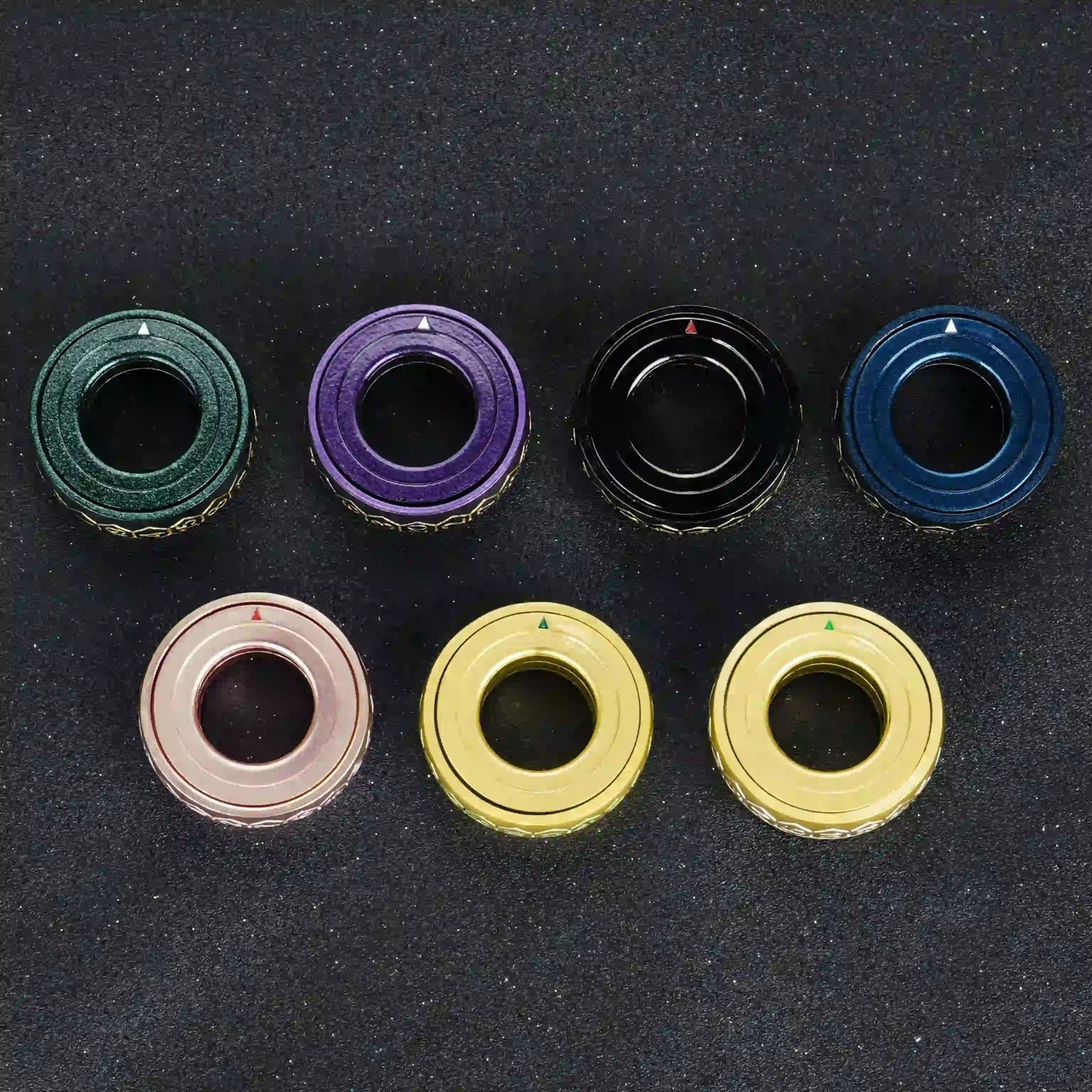 7 cool metallic D20 dice ring colors for fingertip spinning: gradient green, blue, purple, gold, gold with green lettering, black, copper | Bear Dice