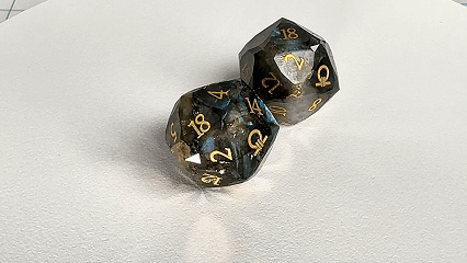 Two natural labradorite DND D20 dice engraved with the Ring of Order pattern are spinning. | Bear Dice