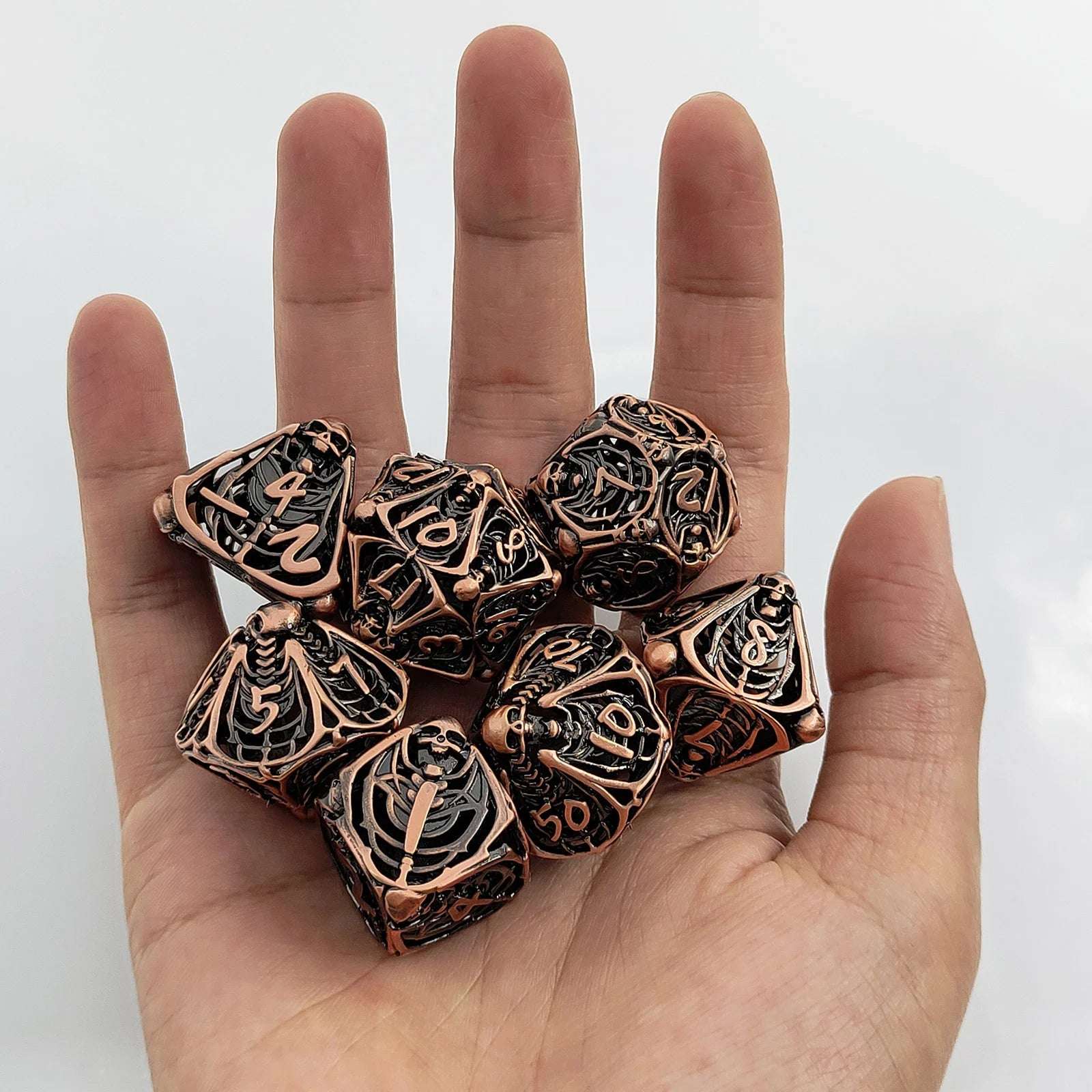 This copper metal hollow Necromancer skull dice set is perfect for role-playing games like Dungeon & Dragons | Bear Dice