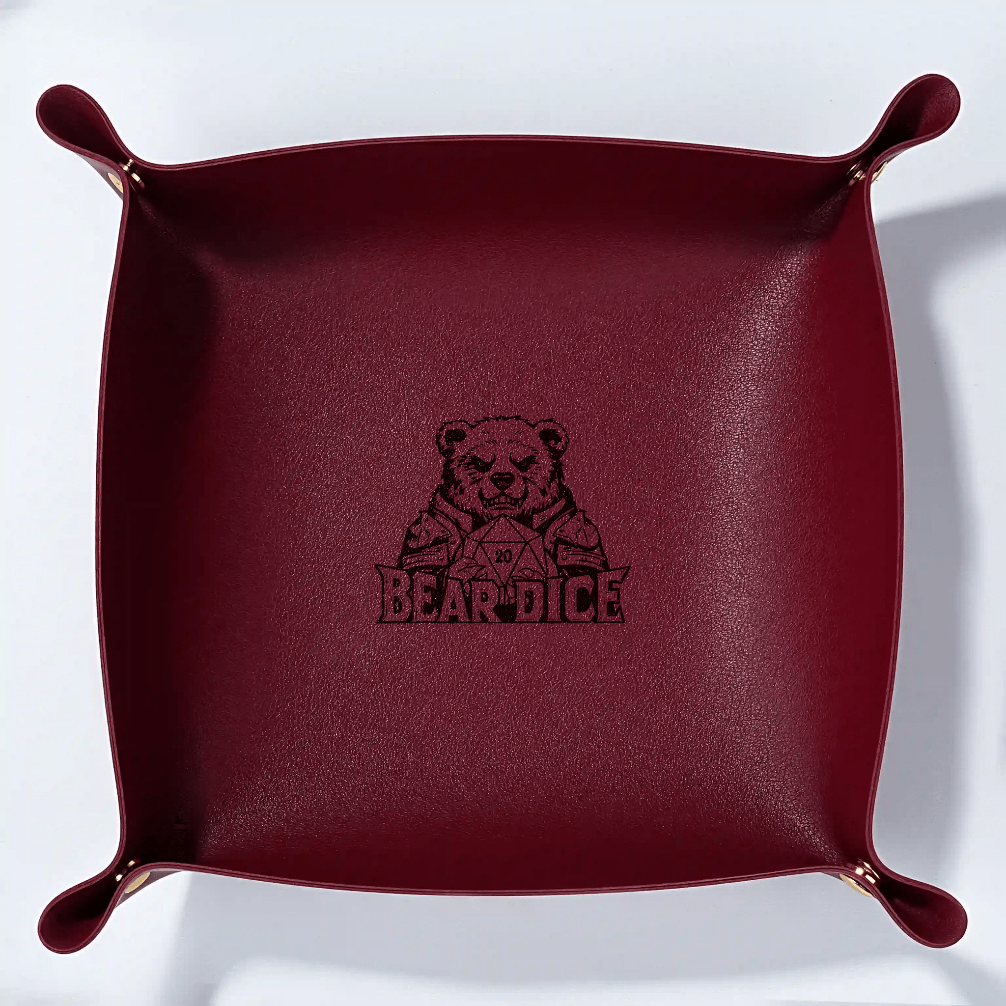 Custom red leather DND dice tray with a button-operated foldable personalized dice roller and pad. A black Bear Dice logo is embossed in the center of the tray.