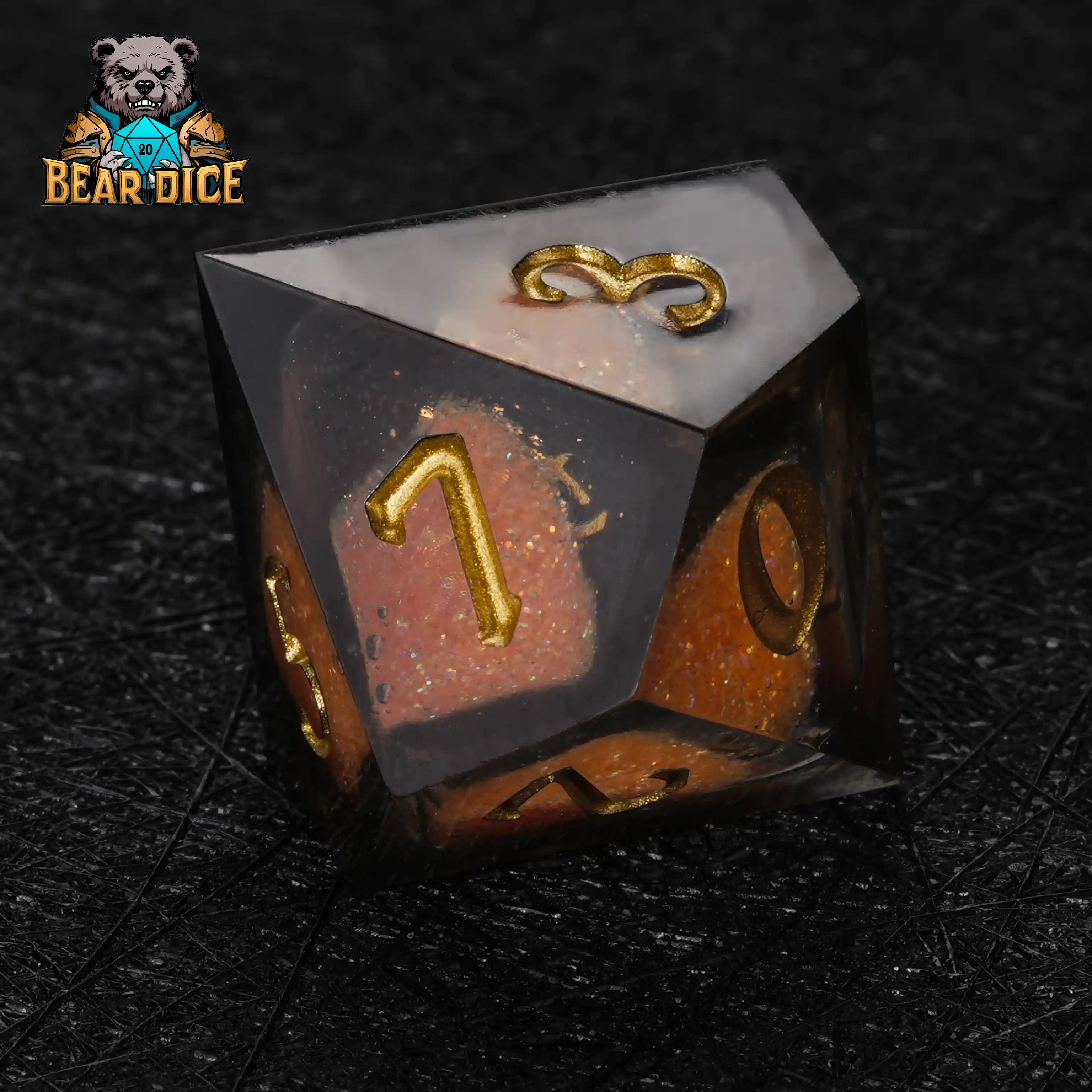 Geometric D10 dice in translucent orange resin with golden numerals
