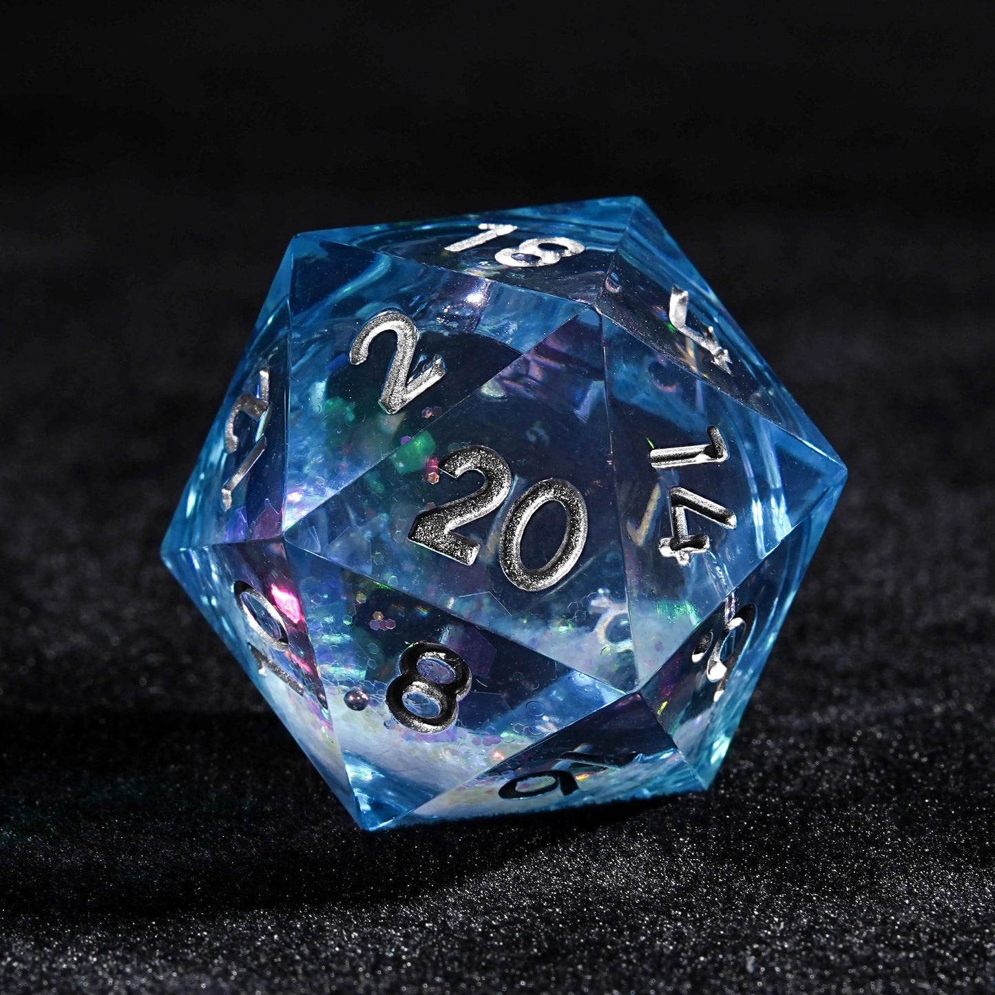 Blue resin D20 dice with colorful sequin quicksand cores | Bear Dice