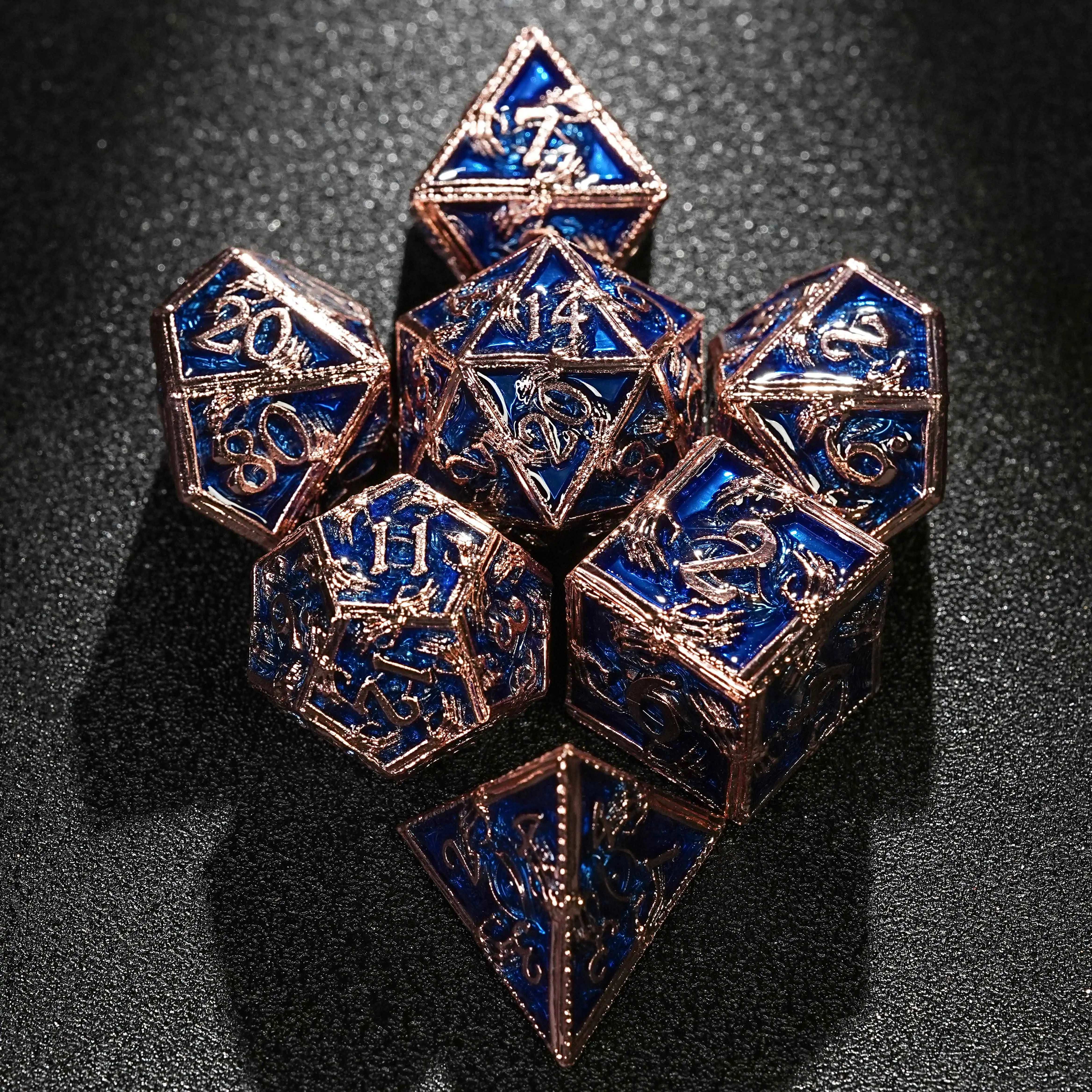 The copper-colored metal skeleton hand surrounds the royal blue DND dice set | Bear Dice