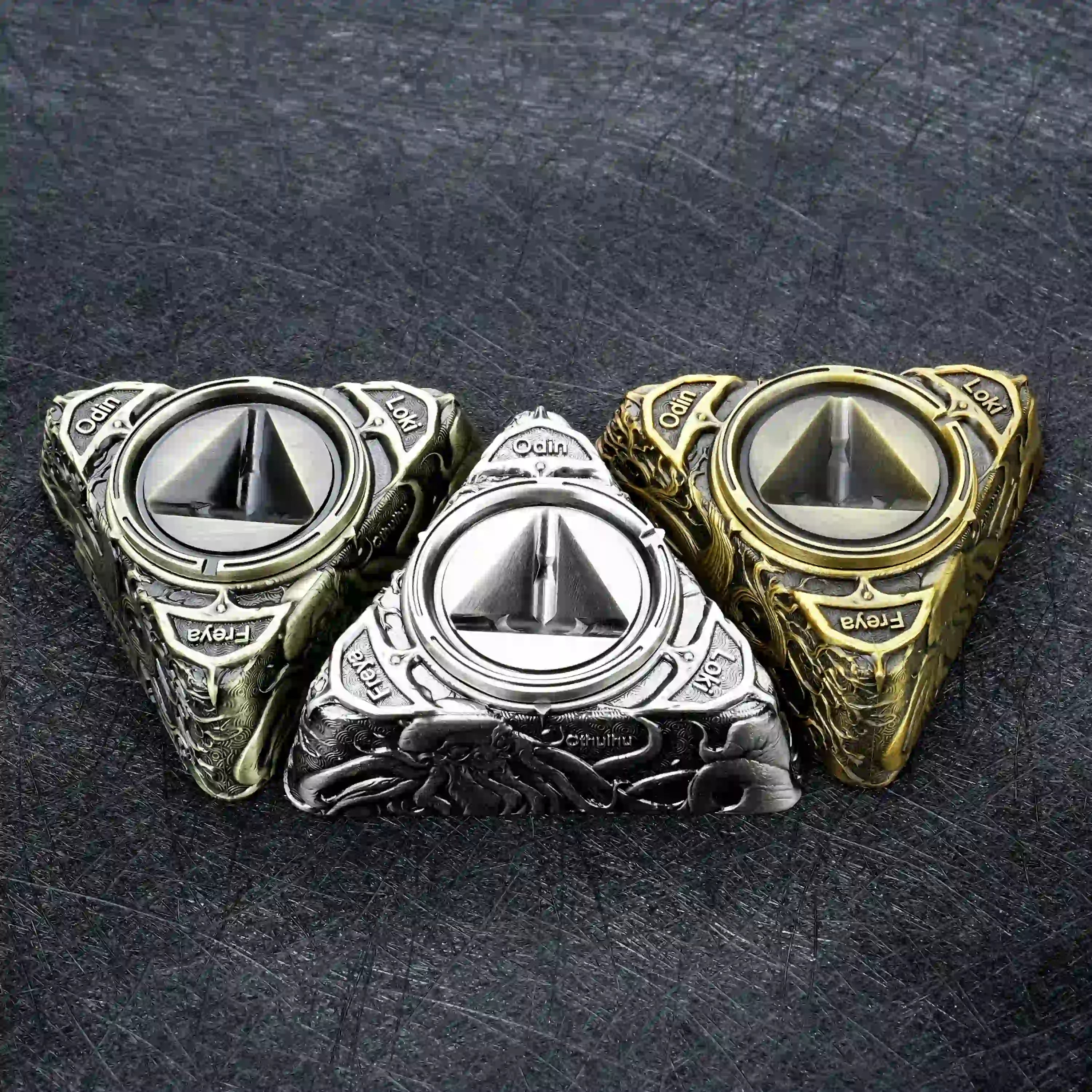 Three different colored D6 spinning dice bases, each engraved with Loki, Odin, and Freya | Bear Dice