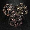Three large 40mm metal hollow dragon D20 dice (blood, copper, and bronze) placed on a black table | Bear Dice