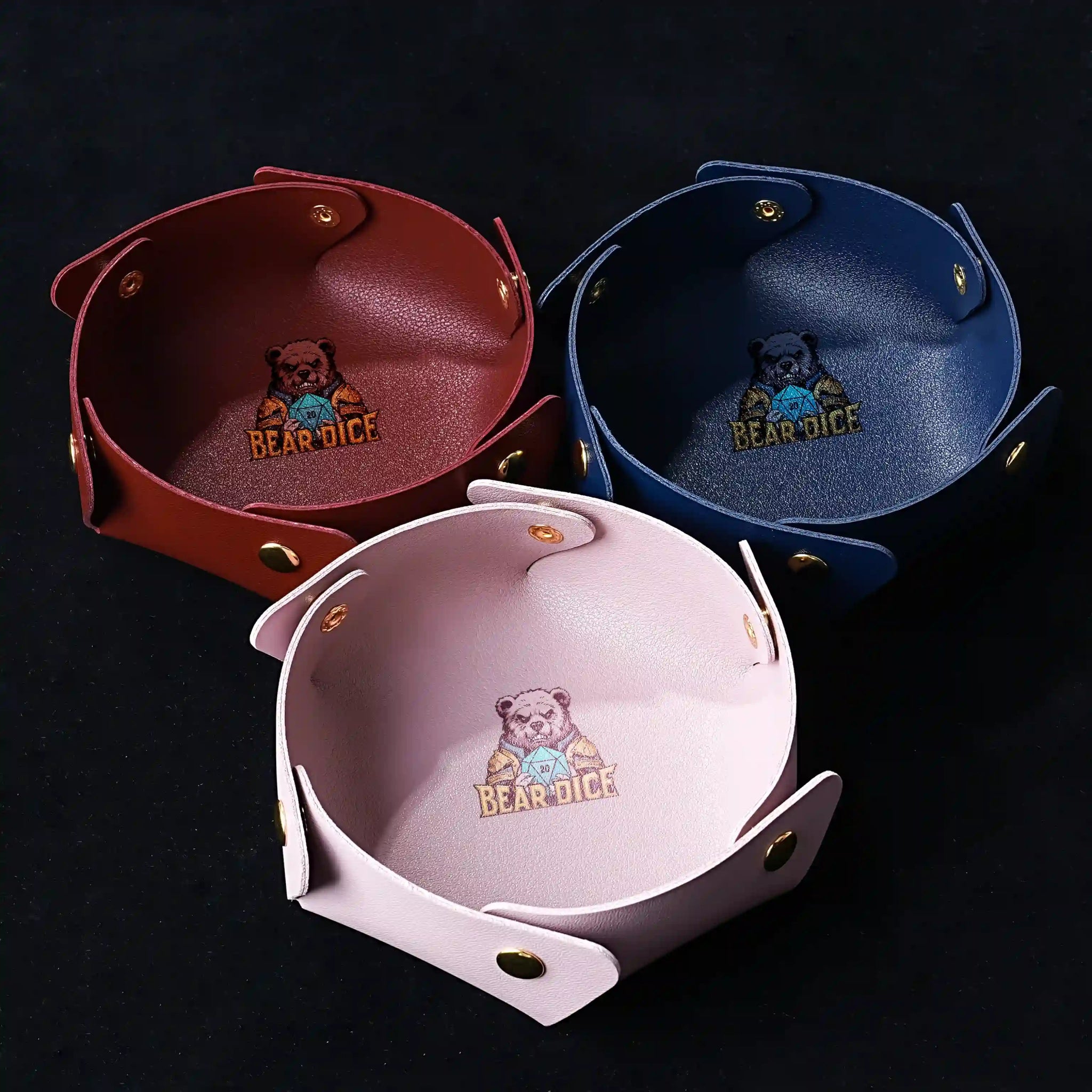 Three snap-on semi-circular leather DND dice trays with the Bear Dice logo, in red, blue, and pink | Bear Dice