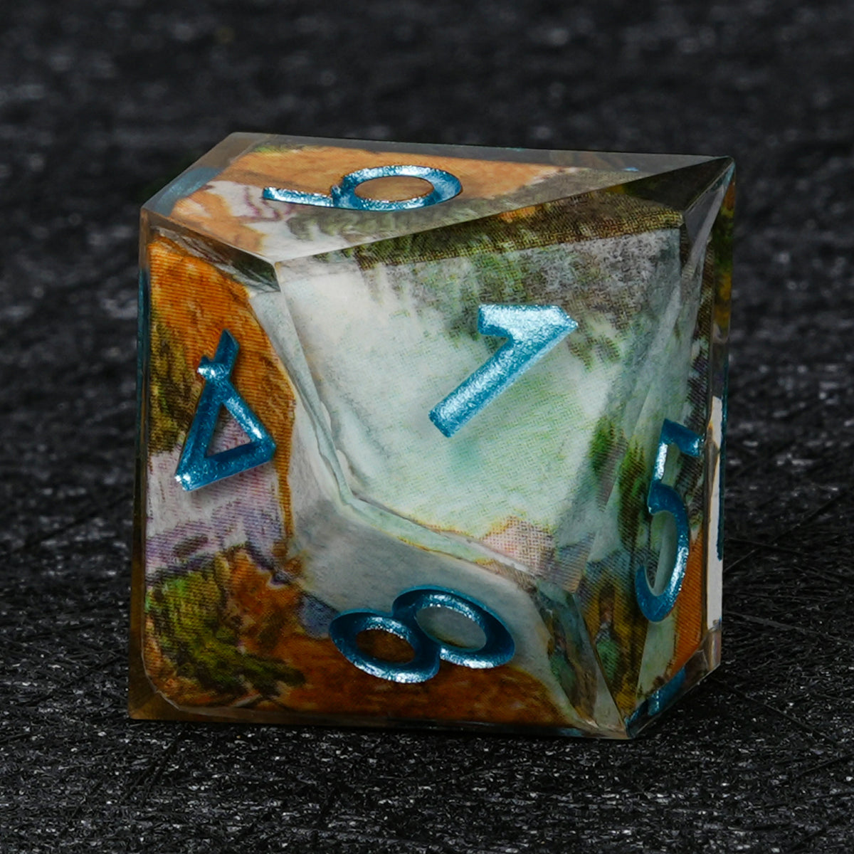 Ten-sided resin D10 with autumn landscape artwork, pale blue and white accents and metallic blue numbers