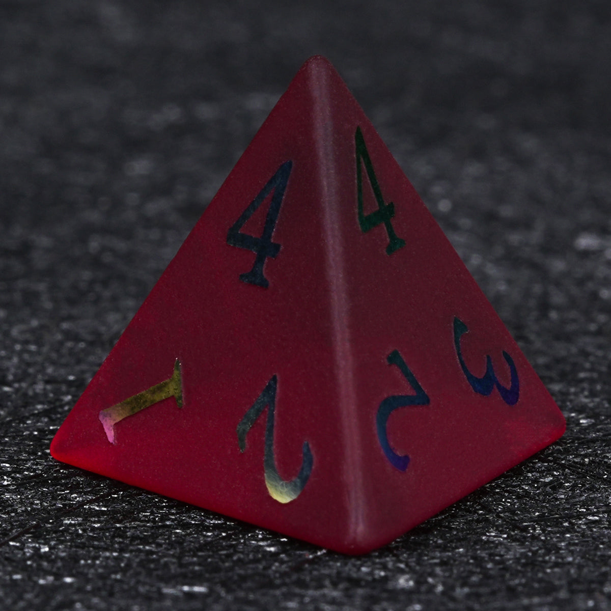 Garnet red frosted glass D4 die with rainbow-plated numbers, showing its triangular pyramid shape against a dark background