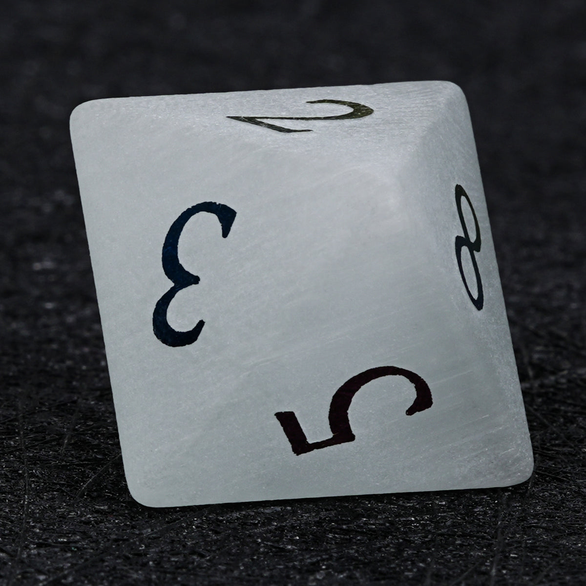 Gray frosted gemstone D8 die with electroplated numbers, showing triangular faces and the numbers 3 and 5.