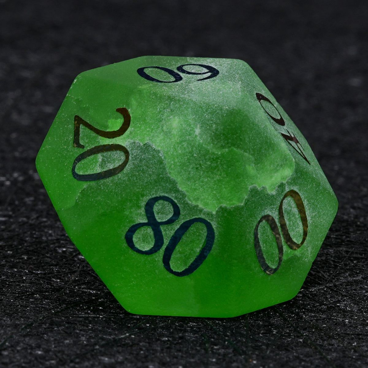 Green crackle frosted glass D100 percentile die with electroplated tens markings, including 80, on a black background.