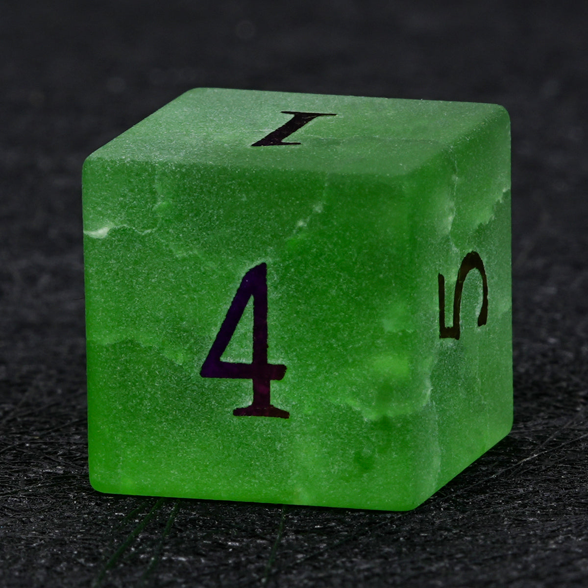 Green crackle frosted glass D6 die with electroplated numbers, showing its cube shape and the number 4 on the front face.
