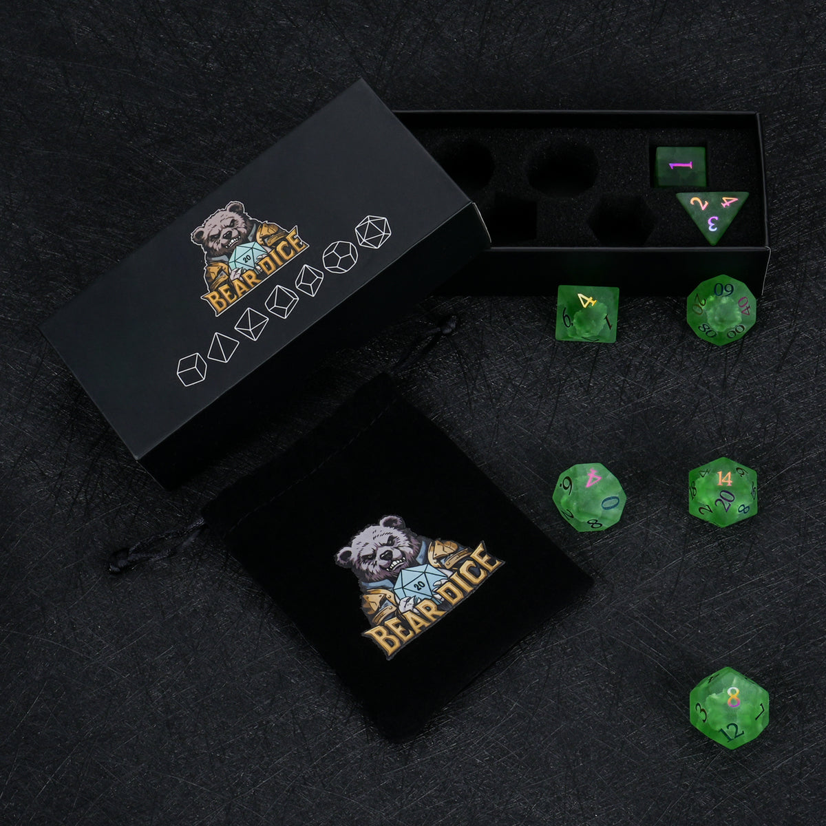 Green crackle frosted glass dice displayed beside black Bear Dice packaging boxes on a dark surface.