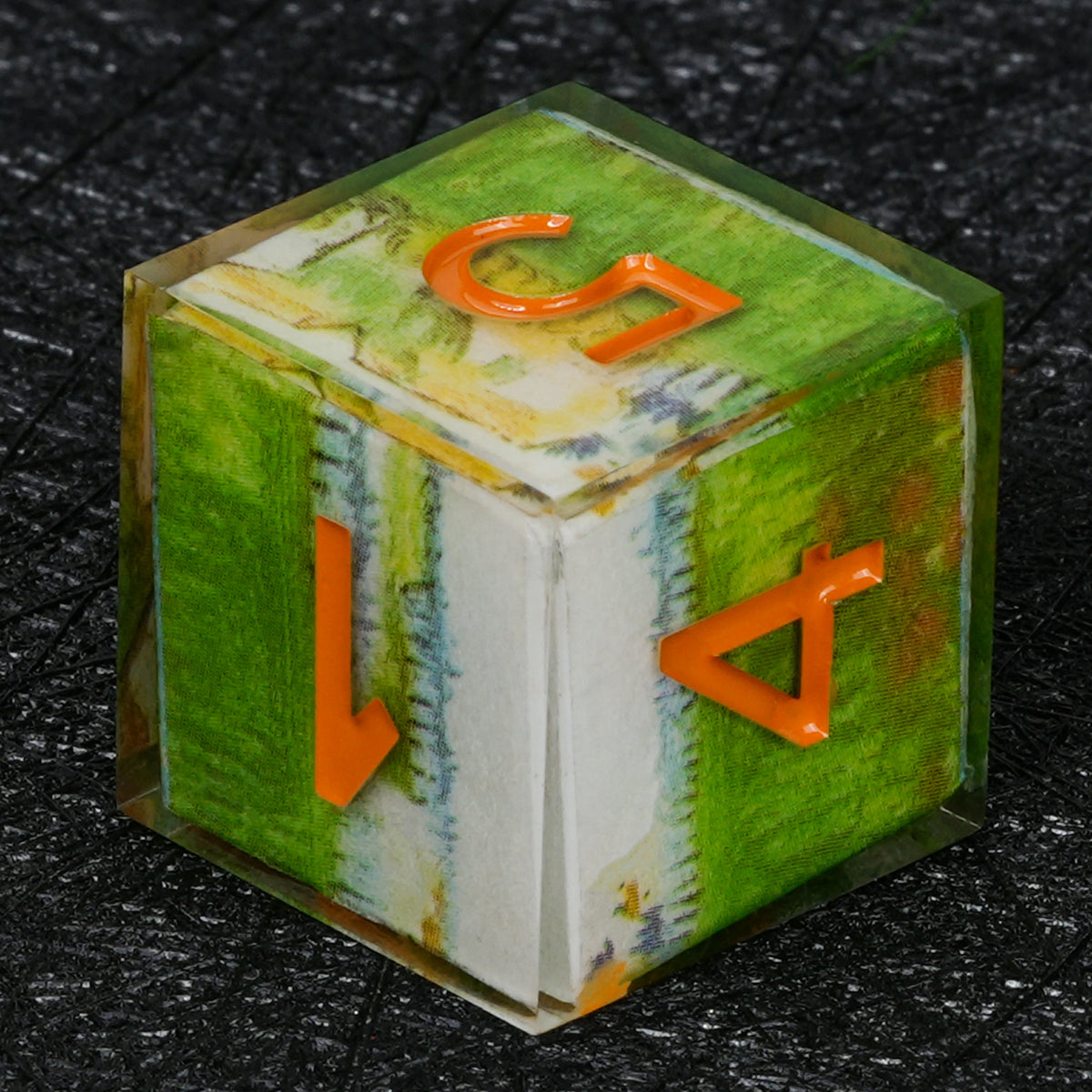 Six-sided resin D6 with green and white landscape decal artwork, orange numbers and clear edges