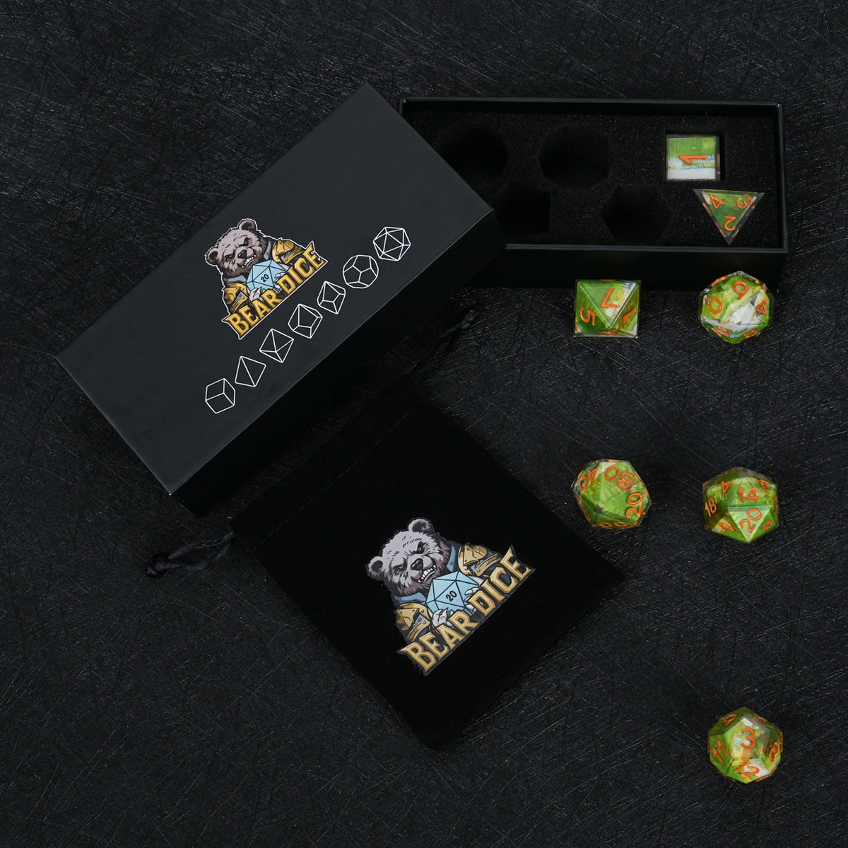Seven green landscape resin dice with orange numbers, displayed with a black Bear Dice box, foam insert and drawstring pouch