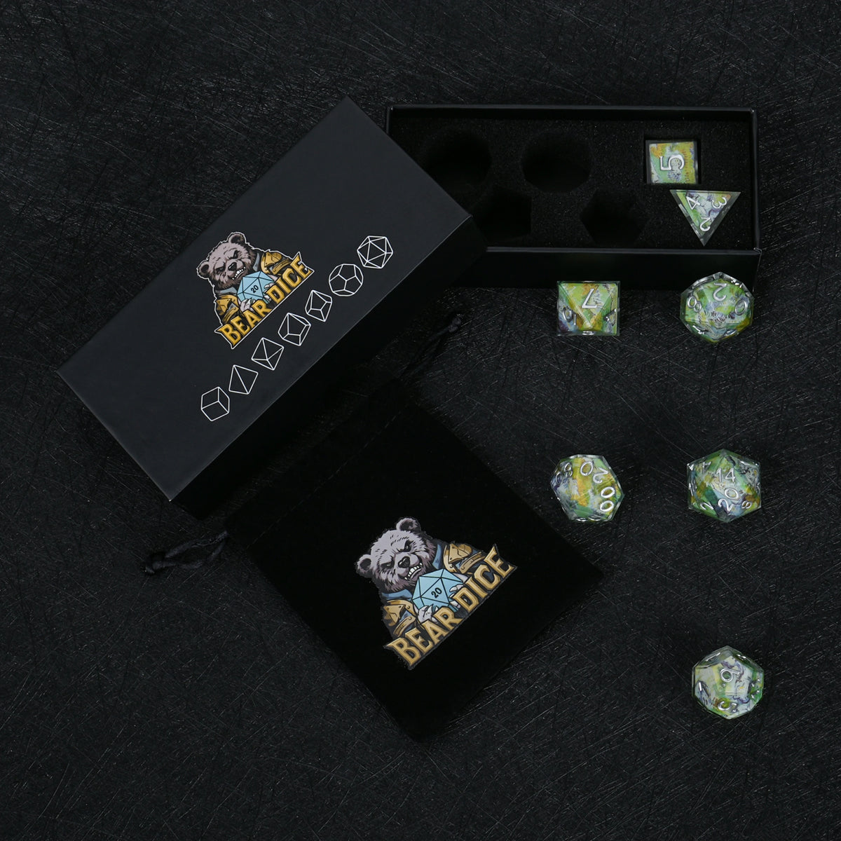 Seven green landscape resin dice with silver-colored numbers, displayed with a black Bear Dice box, foam insert and drawstring pouch