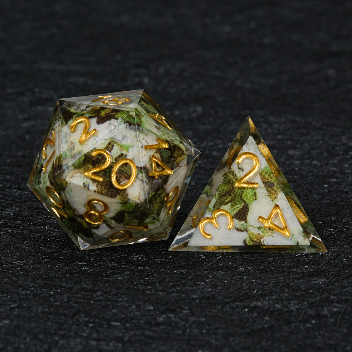Green and white resin D20 and pyramid-shaped D4 with wraparound decal artwork and gold numbers