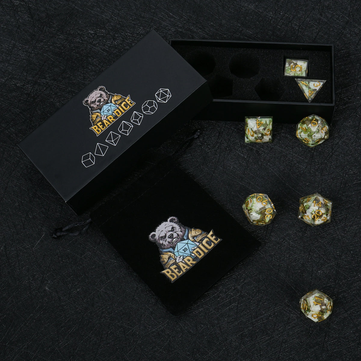 Seven green and white resin dice with gold numbers, displayed with a black Bear Dice box, foam insert and drawstring pouch