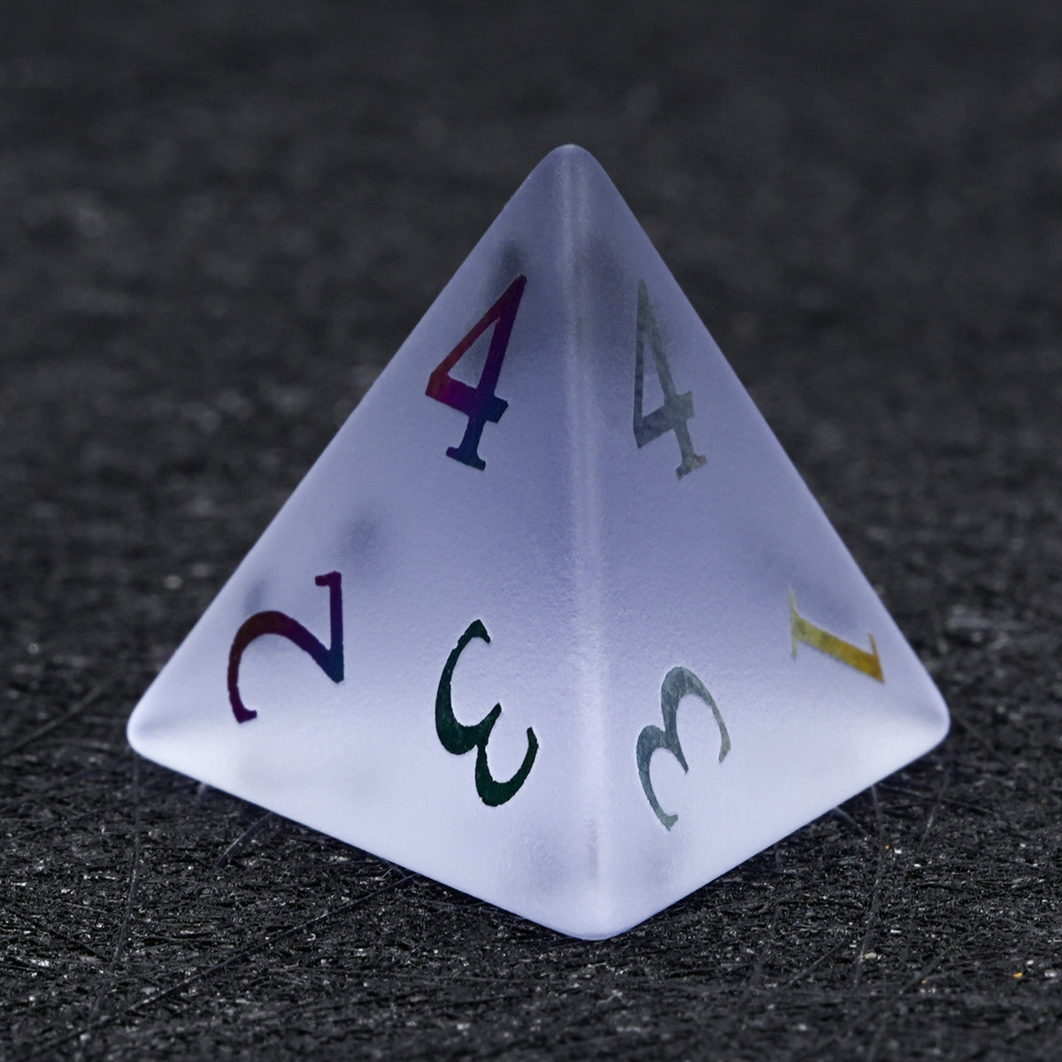 Lavender gemstone D4 die with multicolored numbers, showing its triangular pyramid shape on a black surface