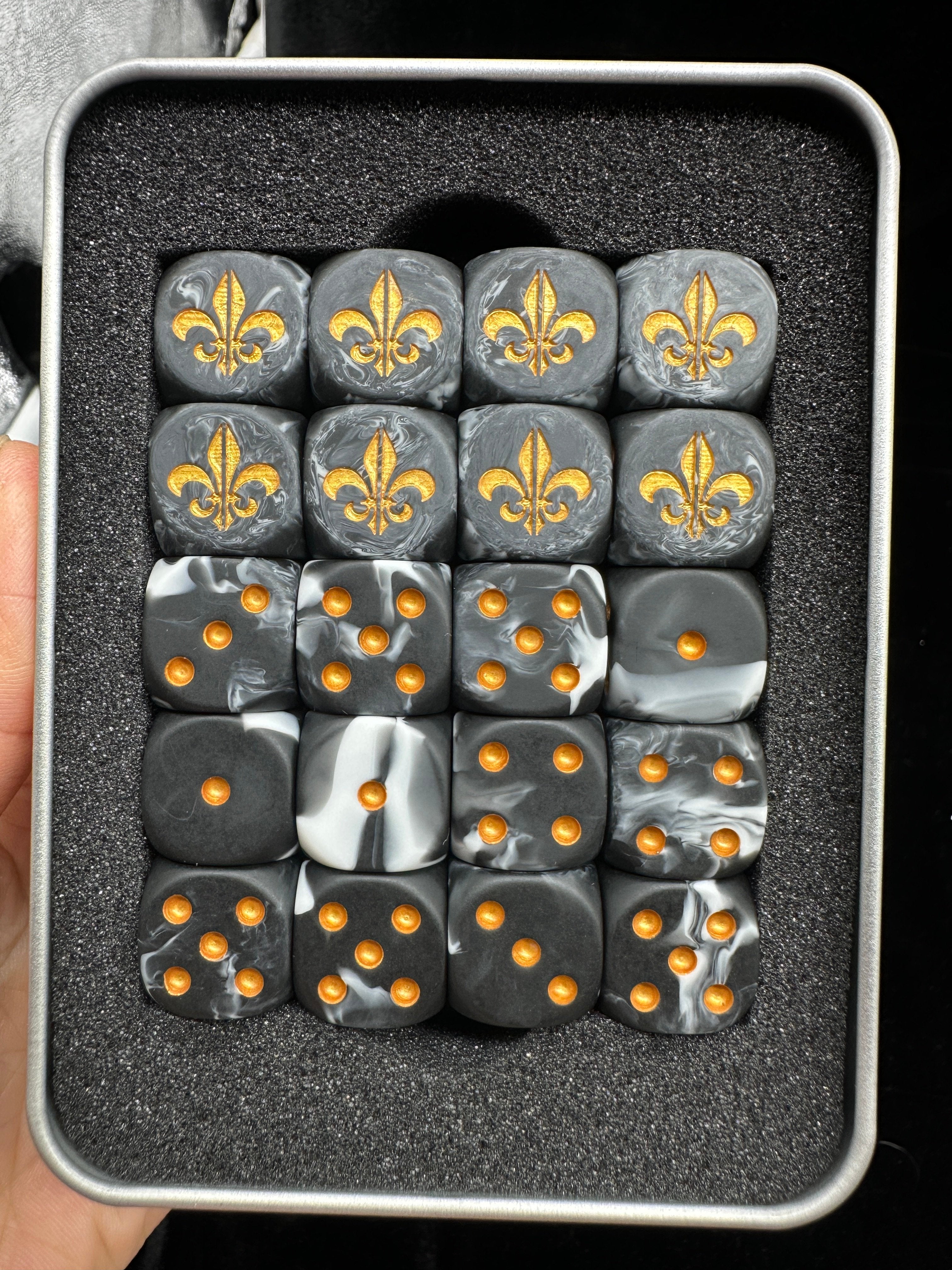 Warhammer 40K Battle Fleur-de-lis Black & White Swirl Acrylic D6 Dice — Hand Size Comparison Showing 16mm Scale, Gold Fleur-de-lis Engraving and Gold Pip Inlays | Bear Dice